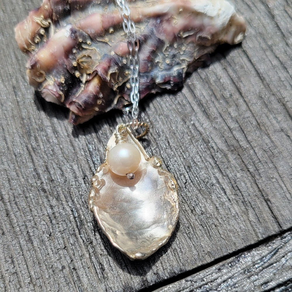Oyster shell pendant with pearl