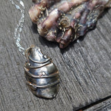 Oyster shell pendant with pearl