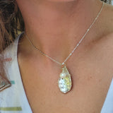 Oyster shell pendant with pearl